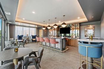 A modern dining area with a bar and a television.